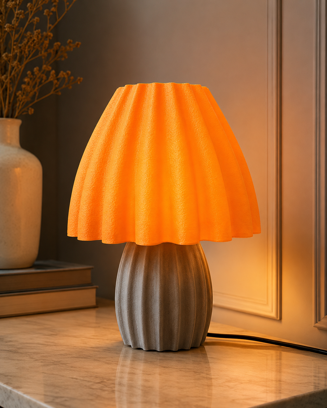 Amber Bloom Table Lamp with orange pleated shade and grey ribbed base